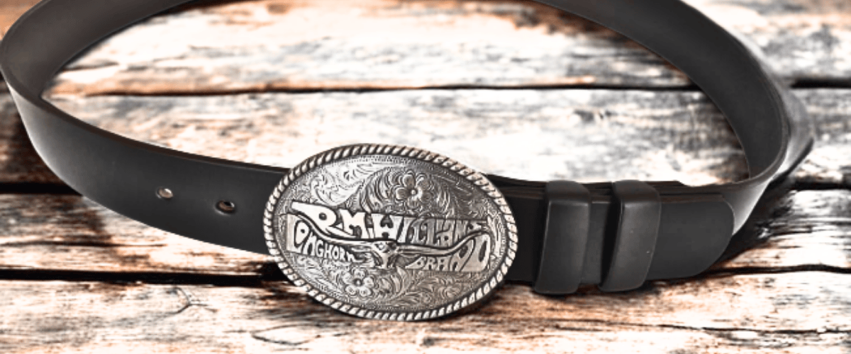 rmwilliams belt with trophy buckle on wood bench - BeltUp Leather Co.