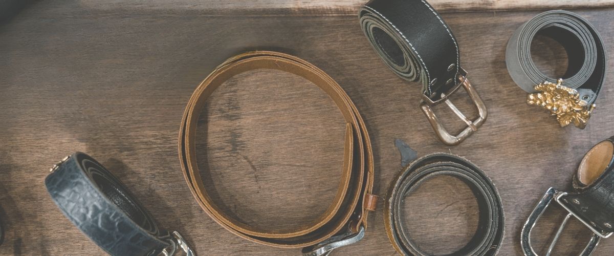 multiple belts rolled up on bench - BeltUp Leather Co.