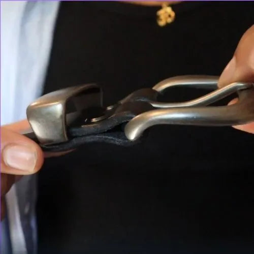 Person holding a black leather belt.